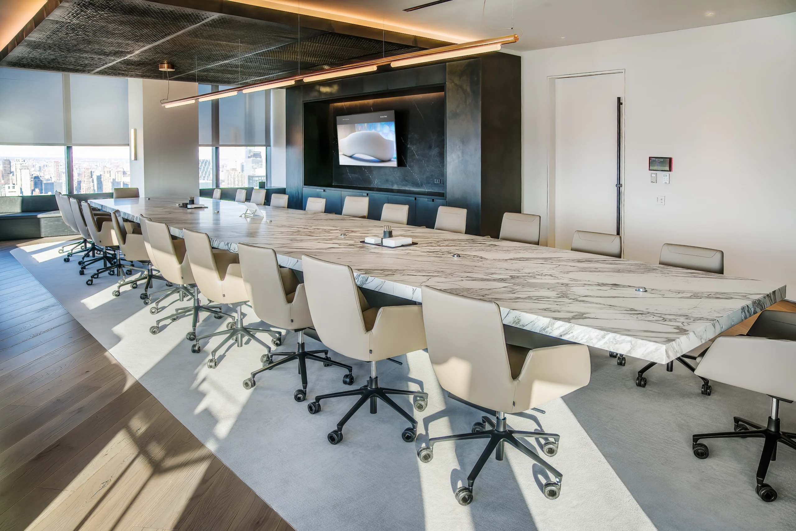 A large conference room with a large table and chairs.