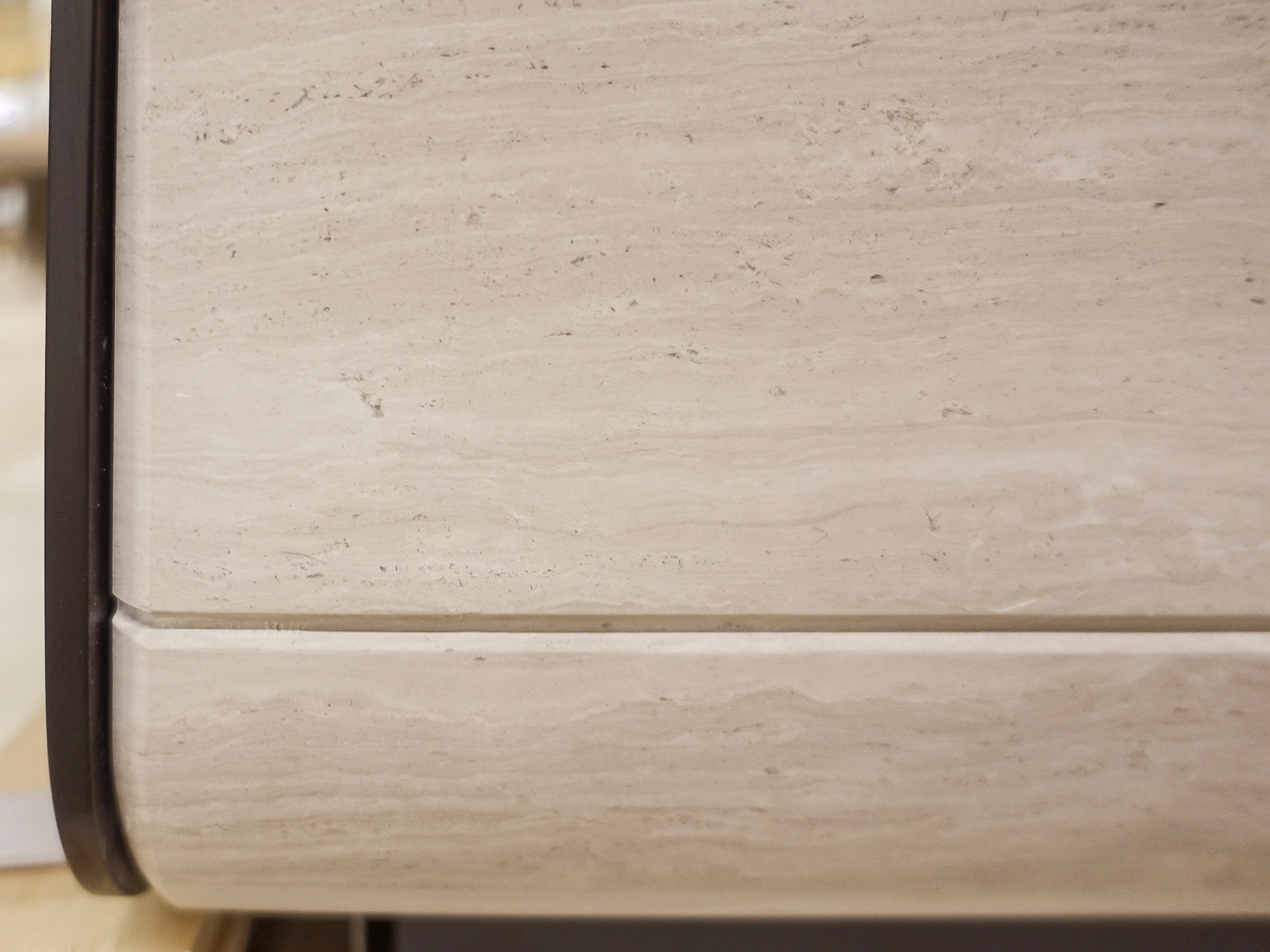 Base detail of a stone and steel reception desk